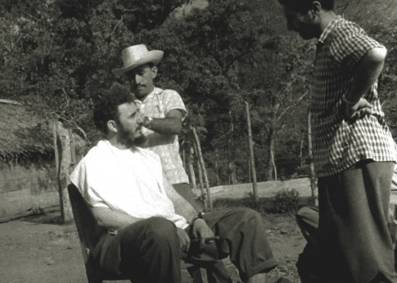 Fidel chatting at a makeshift barber shop in El Naranjo, Sierra Maestra